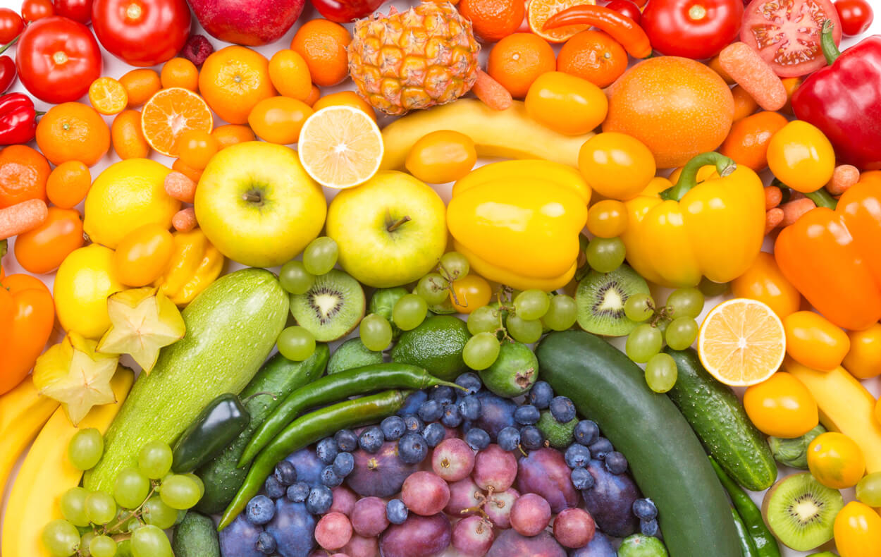 Colorful fruits and vegetables, arranged to look like a rainbow