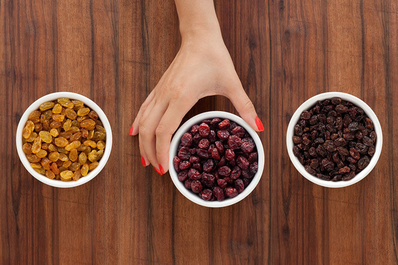 Golden Raisins, Dried Cranberries and Sun-Dried Raisins divided into small cups